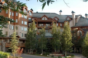 A multi-story hotel with a central courtyard, surrounded by trees and featuring a mix of brick and wood exteriors. - BC Slopeside Ski Studio, Hot Tub, Resort Amenities (Beaver Creek)
