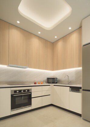 A modern kitchen with built-in appliances, a microwave, and a sink. - Infinity Suites 1, By Hellocrete (Rethymno)