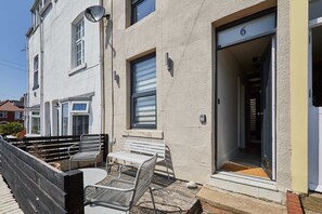 A residential building with a balcony, a bench, and a door marked with the number 6. - Host Stay Casa Formentera (Scarborough)