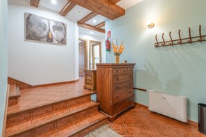 A staircase leading to a room with a wooden dresser and a radiator. - La Casona De Cuéllar: Rural House for Groups with Pool in Segovia (Cuéllar)