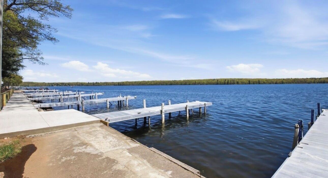 A calm lake with docks extending into the water.