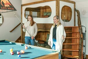 A pool table with balls, a wooden headboard, and a ladder. - Twilight Timber at Saluda Mountain Retreats! (Saluda)