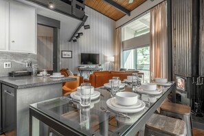 A modern kitchen with a dining area, a fireplace, and a television. - Spacious 2BR + Loft Mammoth Escape 680 (Mammoth Lakes)