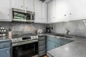 A modern kitchen with a stainless steel range, microwave, and oven. - Spacious 2BR + Loft Mammoth Escape 680 (Mammoth Lakes)