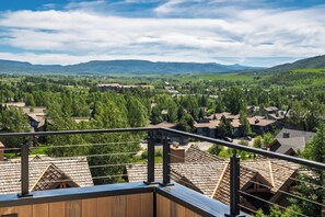 Ein Wohngebiet mit mehreren Häusern, blauem Himmel und fernen Bergen.