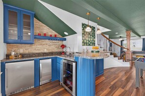 A kitchen with blue cabinets, a wooden countertop, and a built-in oven. - Wildlight House: Cascade | Canyon Lake | Sleeps 17 (Canyon Lake)
