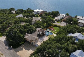 An aerial view of a residential area with houses, a swimming pool, and a gazebo. - Wildlight House: Cascade | Canyon Lake | Sleeps 17 (Canyon Lake)