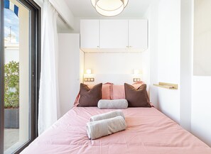 A bedroom with a bed, pillows, a bedside table, and a window. - Mamabaldi Apartment – Elegance, tranquility and views from the top of Nice (Nice)