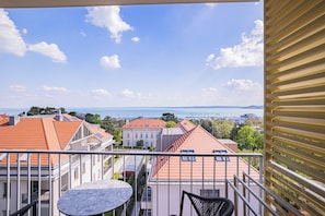 A balcony with a view of a marina and buildings.