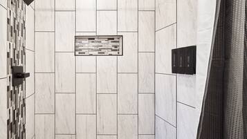 A tiled wall with a geometric pattern and a rectangular inset panel.