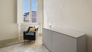 A room with a chair, a desk, and a window with a view of buildings outside. - Holiday Home 'Villa Lucia' with Sea View, Wi-Fi & Air Conditioning (Viareggio)