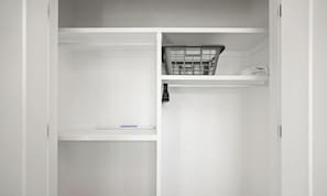 A white wardrobe with a hanging basket and a shelf. - The Grande | AC |Garage | Yard | 10 min to Rogers (Edmonton)