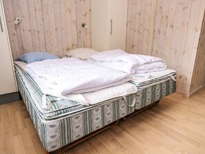 A single bed with a patterned mattress and white bedding. - 4 Star Holiday Home in Albaek (Aalbaek)