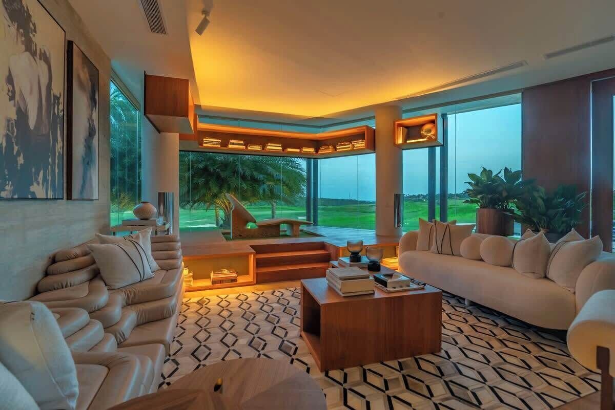 A modern living room with a sofa, coffee table, and artwork on the wall.