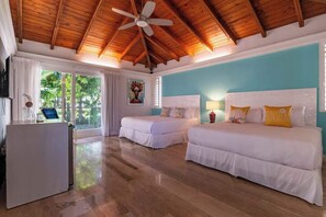 A room with two beds, a ceiling fan, and a desk with a chair. - Villa Vega de Palma. Luxurious villa .Golf view (La Romana)