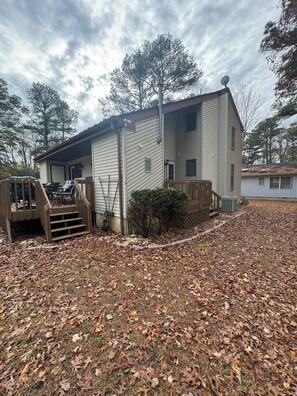 A single-story house with a covered porch and a small deck. - Cozy 3-bedroom house in charming Ocean Pines with AC (Ocean Pines)