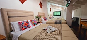 A hotel room with two beds, a desk, a chair, and a window with curtains. - Hotel Choqechaka  (Cusco)
