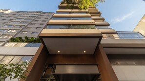 A modern building with a unique stepped design, large windows, and a flat roof. - Studio with Pool near the Subway | Vila Mariana (São Paulo)