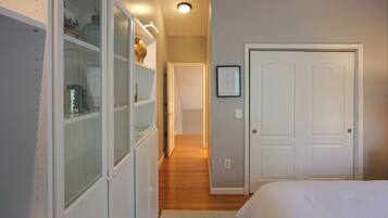A bedroom with a bed, a wardrobe, and a door.