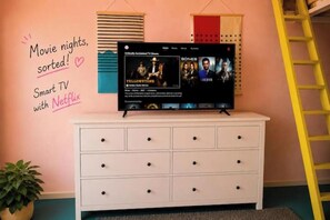 A white dresser with a flat-screen TV displaying a Netflix interface. - Colour Pop Flat – Near the Canal, 1m from the Station (London)