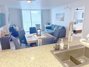 A hotel room with a dining area, a sofa, a bed, and a bathroom. - Haven on Brickell Bay (Miami)