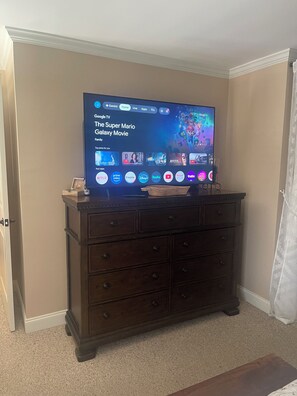 A television on a wooden cabinet displaying the Google TV interface with the Super Mario Galaxy Movie highlighted. - JAMBO @ Cades Cove Landing Unit 110 (Townsend)