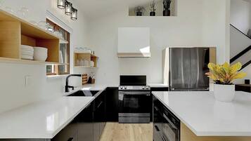 Seamlessly connected to the living area, this fully equipped kitchen and adjacent dining space make hosting effortless, whether you're whipping up a quick breakfast or settling in for a family dinner.