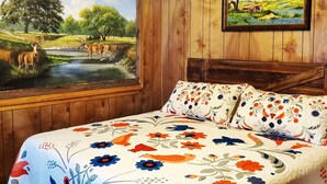 A room with a bed, a large window with a painting of a landscape, and a smaller framed painting on the wall. - Enjoy Longhorns at Texas Ranch House near Canyon Lake & Gruene – Sleeps 12 (New Braunfels)