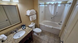 A bathroom with a sink, toilet, and bathtub. - Carolinian Resort  Ocean View Condo (Myrtle Beach)