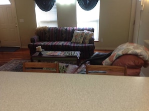 A living room with a sofa, a coffee table, and a chair.