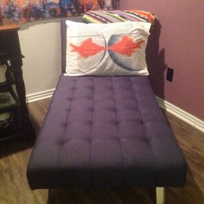 A small, purple, tufted bench with a pillow featuring two red fish designs. - Downtown Bohemian Bungalow Full Bed Bottom TwinTop (Fayetteville)