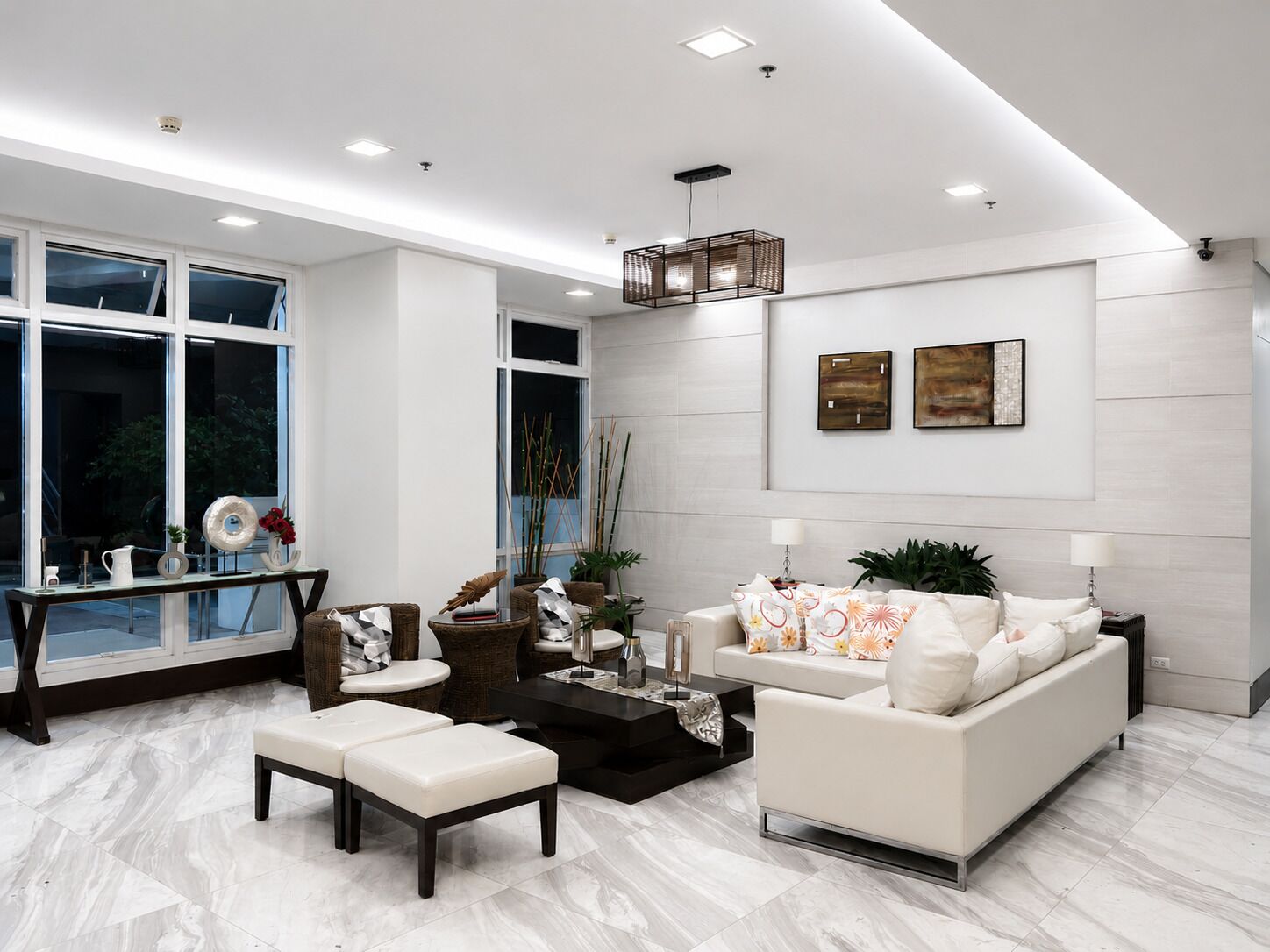 A modern living room with a sofa, coffee table, and seating area.