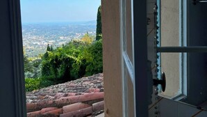 An open door leading to a balcony with a city view. - Stunning villa with a pool and ocean view, Mediterranean garden, sleeps 8 (Grasse)
