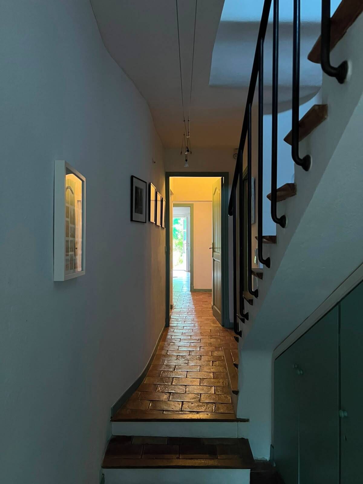 A staircase with a wooden floor leading to a door at the end.