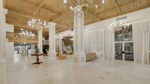 A spacious lobby with high ceilings, chandeliers, and a grand staircase. - Penthouse Paradise on Palm Beach Island (Palm Beach)