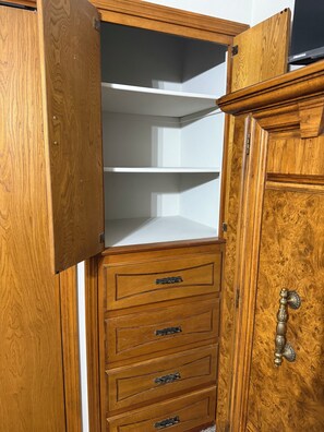 A wooden cabinet with multiple drawers and a shelf, featuring metal handles and a decorative knob. - 3 bed/2 bath Home- Livestock Facilities Available (Vici)