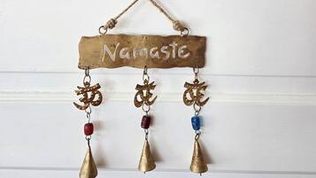 A decorative hanging with a nameplate and three hanging ornaments.
