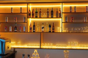 A bar area with shelves of various bottles and glasses. - Meraki Hotels & Resorts Sikkim (Gangtok)