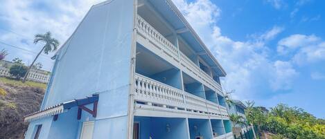 A multi-story building with a balcony on the second floor.