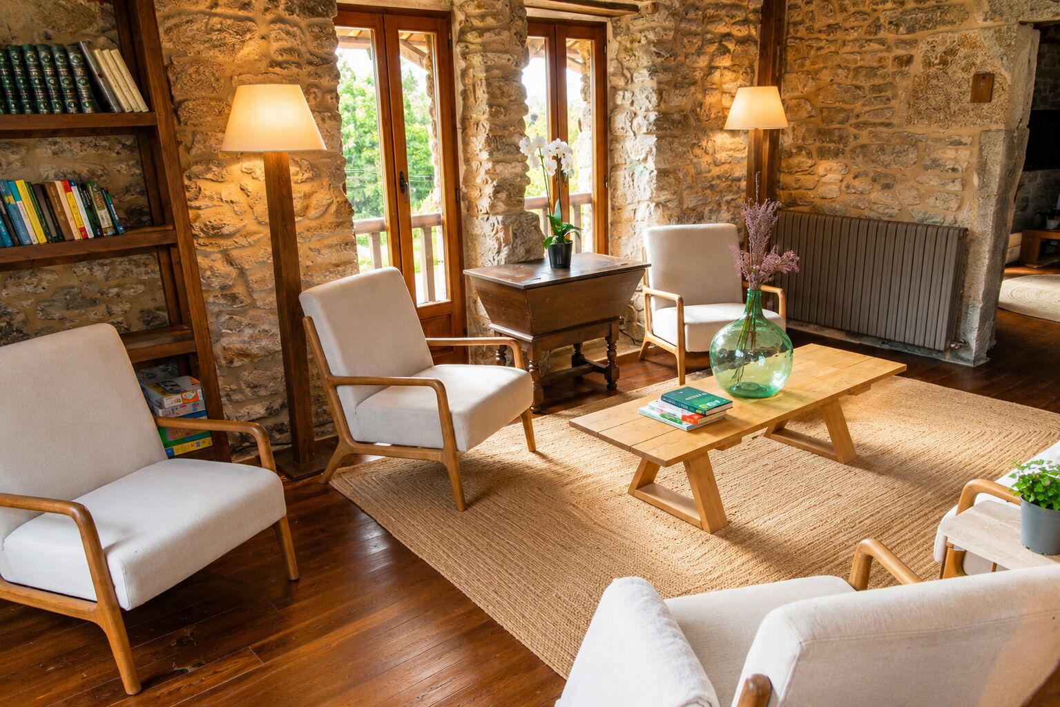A cozy living room with a stone wall, wooden furniture, and a view through a glass door.