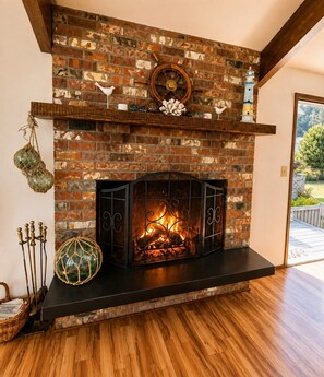 A fireplace with a brick wall, a mantel shelf, and a wooden floor.