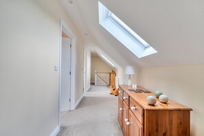 A hallway with a skylight, wooden dresser, and a staircase in the background. - The Donkey Shed -  Sherborne, Dorchester, sleeps 6 guests  in 3 bedrooms (Sherborne)