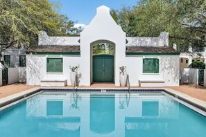 Ein Swimmingpool mit einem weißen Gebäude im Hintergrund.