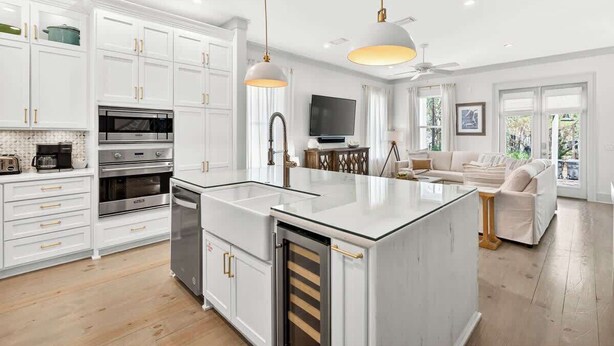 A modern kitchen with white cabinetry, stainless steel appliances, and pendant lighting. - Luxe Beach House: Steps to Rosemary, Beach, Pool & Bikes (Inlet Beach)
