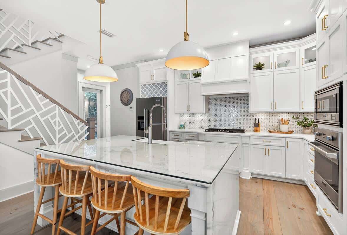 Stay Salty 30A boasts a modern, fully stocked kitchen featuring custom white cabinetry, high-end stainless steel appliances, custom countertops, and a large center island —ideal for gathering and entertaining.