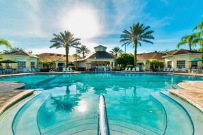 A swimming pool with lounge chairs and palm trees. - Coconico Retreat At Windsor Palms (Kissimmee)