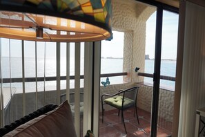 A balcony with a view of the sea, a chair, and a cushion. - Marina Pinacate B-302 (Puerto Peñasco)