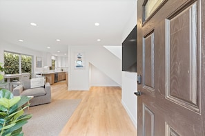 A modern interior with a living area, kitchen, and dining space. - Spacious Coastal Getaway. Walk to Windansea beach, coffee shops, restaurants. (La Jolla)