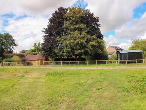 A fenced property with a large tree, a small building, and a barn. - The Old Mill (Telford)