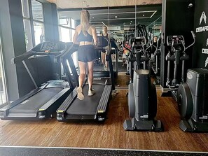 A gym with treadmills, elliptical machines, and other fitness equipment. - Barranco Luxe | A/C • Rooftop Pool & Hot Tub • Gym ⭐ (Barranco)